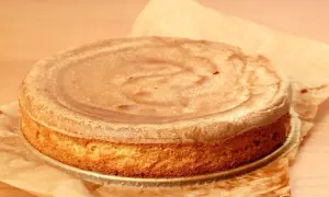 Puszysty biszkopt z 10 jaj, lekko zarumieniony, na papierze do pieczenia. Idealny do tortu.