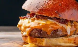 Soczysty burger z rozpływającym się serem i chrupiącym boczkiem. Zastanawiasz się, ile kalorii ma wieśmac? Ten wygląda na bogaty w smaku i kalorie!