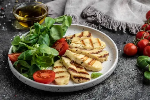 Pyszne halloumi z grilla podane z sałatką i pomidorkami. Idealna propozycja na lekki posiłek.
