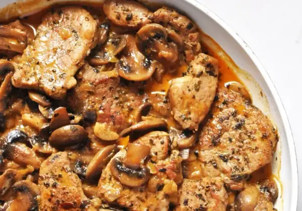 Soczysta polędwica wieprzowa z piekarnika, duszona z pieczarkami w aromatycznym sosie. Idealna na obiad.
